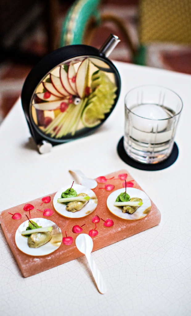 Verger, a cocktail made with vodka, cider syrup and manzana, infused with fan-shaped apples, lemon strips and zest, cinnamon and apple blossom.