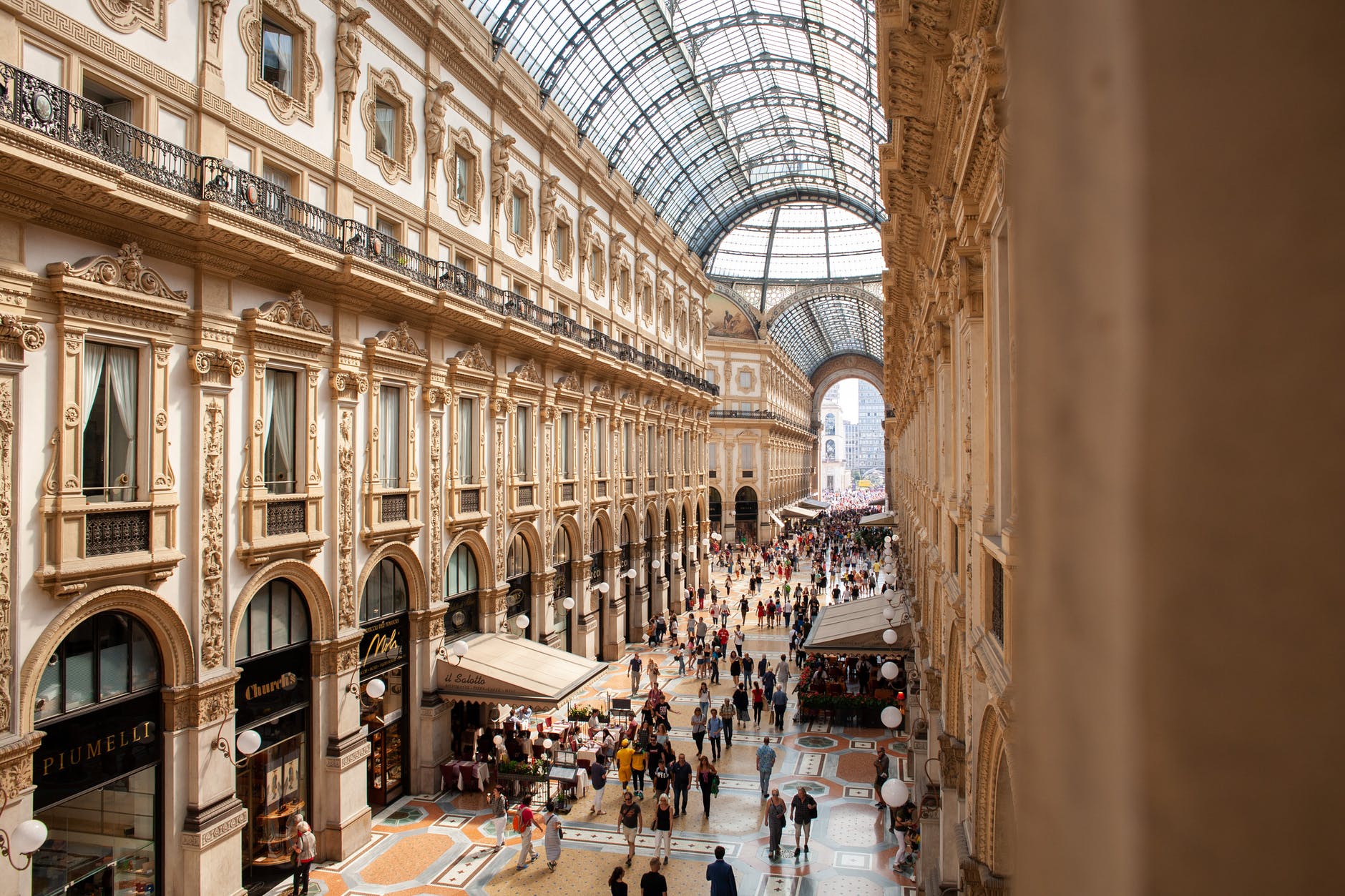 people inside galleria vittorio emanuele ii shopping mall in italy