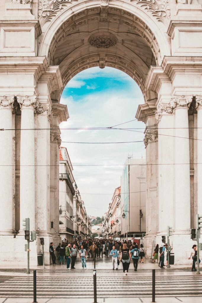 people walking under white concrete architecture