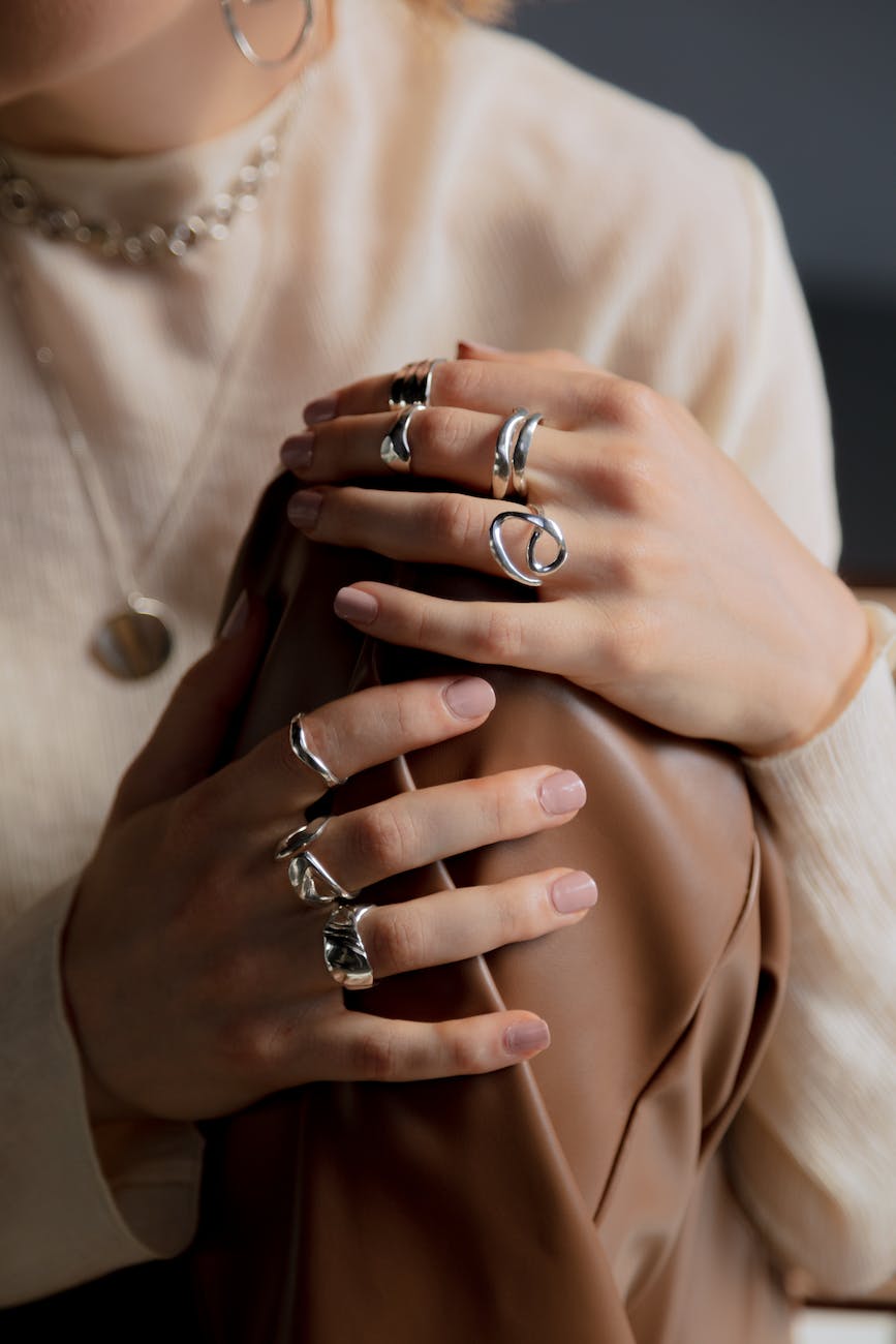 close up photo of silver rings worn by a person