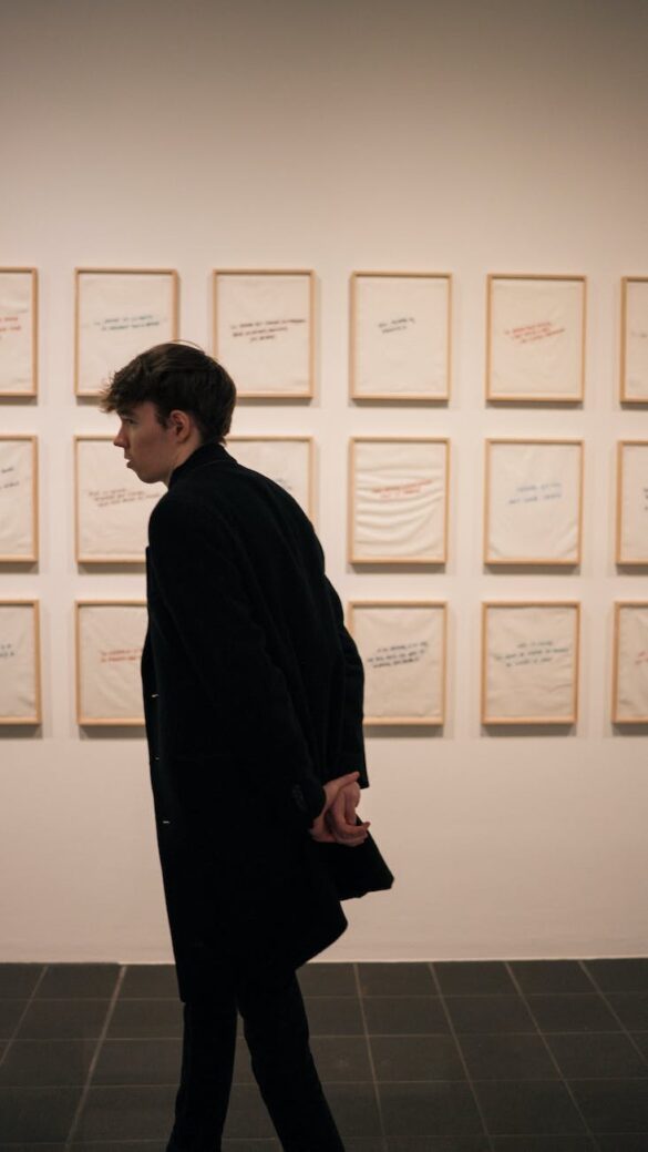 man in black coat in art gallery
