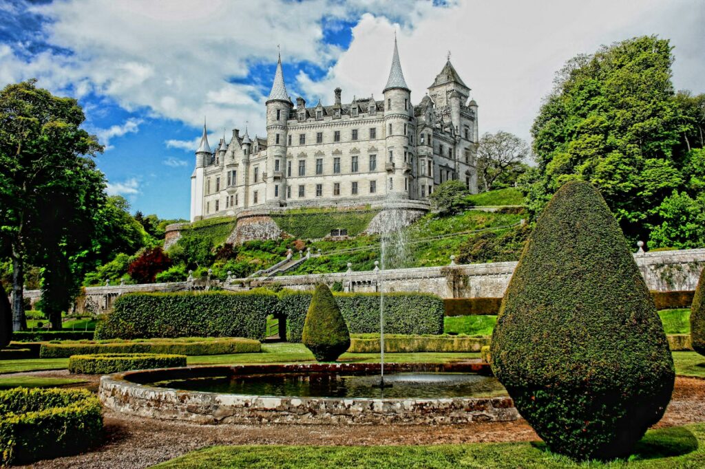 white concrete castle surrounded by green plants