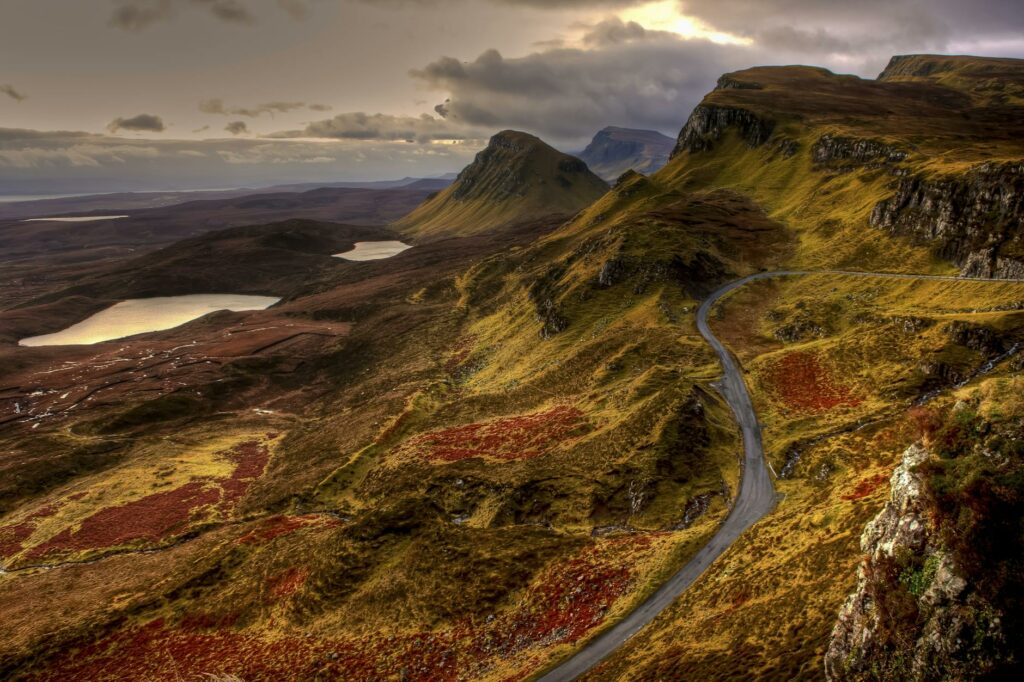 green grass covered mountain range with road